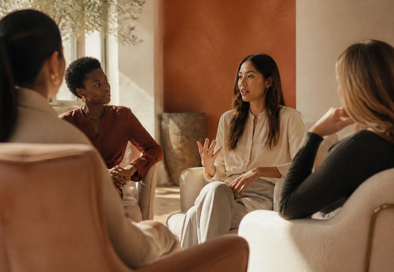 Women in conversation in a warm, sunlit room